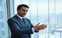 Persuasive Business Jimenez, assertive, negotiating a deal, photorealistic, high-rise office with cityscape, highly detailed, subtle shadows from blinds, crisp resolution, sleek grays and blues, afternoon natural lighting, shot with a 50mm prime lens.